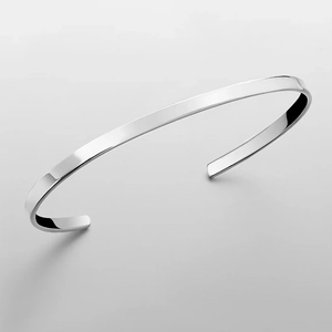 Close-up of polished silver stainless steel C-shaped open cuff bracelet for men