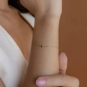 Minimalist gold titanium steel chain bracelet with a rectangular green zircon stone