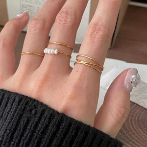 Five-piece minimalist gold stainless steel ring set with natural freshwater pearls
