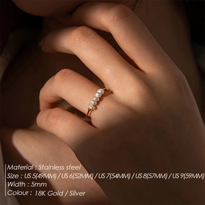 Macro shot of five white freshwater pearls set on an 18K gold plated stainless steel ring