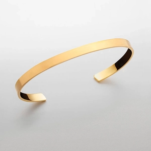 Minimalist polished stainless steel open bangle bracelet in a sleek gold finish for men