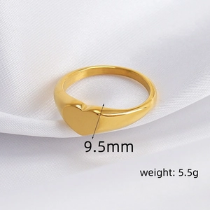 Detail view of a 9.5mm wide heart-shaped gold ring weighing 5.5g on white silk
