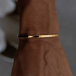 Minimalist gold stainless steel open bangle bracelet with a polished mirror finish for men