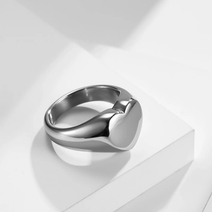 Detailed view of heart-shaped silver signet ring with a high-polished mirror finish
