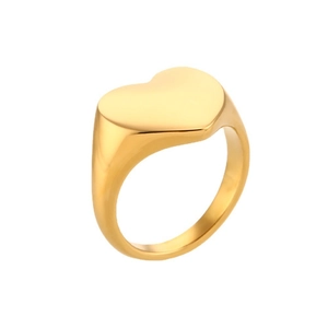 Macro detail of polished gold-plated stainless steel ring with heart-shaped seal design