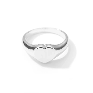 Detailed view of heart-shaped signet ring with a polished silver metallic finish