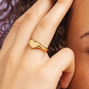 Minimalist heart signet ring in gold-plated stainless steel shown on model hand