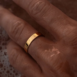 Minimalist waterproof gold plated stainless steel flat band ring shown in water