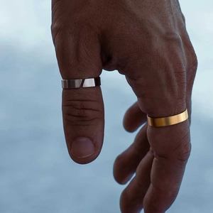 Minimalist silver open ring and gold band in titanium steel worn on hand for women