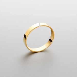 Detailed close-up of a minimalist 18K gold-plated open ring with a polished flat surface