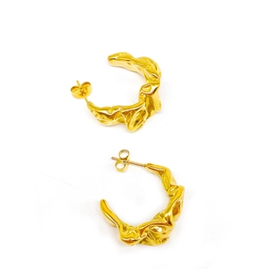 Golden C-shaped earrings with irregular lava texture and modern wrinkled metal design