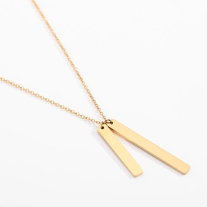 Macro view of golden double vertical bar pendant necklace with sleek polished finish