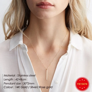 Minimalist vertical bar pendant necklace in stainless steel on female model