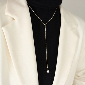 Chic gold-plated Y-shaped pearl pendant necklace for women on minimalist blazer outfit