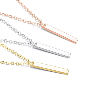 Detailed view of three minimalist rectangular bar necklaces in gold, silver, and rose gold