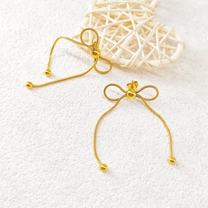 Elegant gold bow earrings with snake chain texture and long dangle drops for women