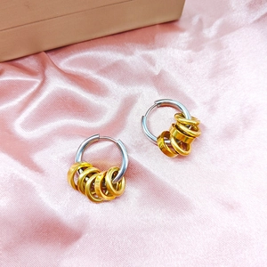 Minimalist two-tone stainless steel hoop earrings with six gold small rings on pink silk