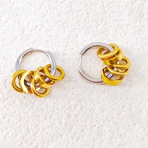 Minimalist two-tone stainless steel hoop earrings with silver base and sliding gold rings