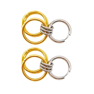 Macro shot of 18K gold and silver interlocking circles showing polished metal texture