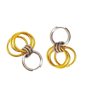 Macro view of interlocking mixed metal rings in gold and silver finish with detailed texture