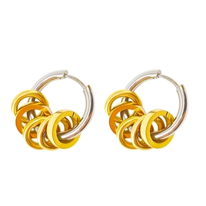 Macro shot of silver stainless steel hoop earrings with gold contrasting small ring charms