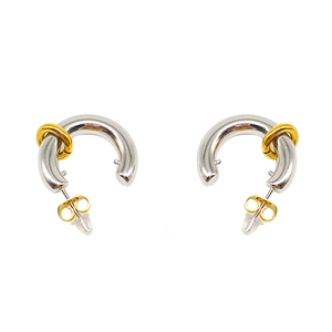 Detail showing two-tone C-shape hoop earrings in polished silver with gold rings