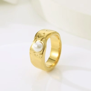 Detail of gold liquid lava textured ring featuring a white baroque pearl on top