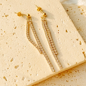 Elegant gold-tone long tassel drop earrings featuring sparkling double-row cubic zirconia