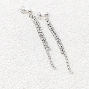 Detail of silver long tassel earrings with double rows of sparkling cubic zirconia stones