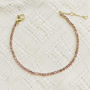 Elegant gold-tone tennis bracelet with tiny round-cut pink cubic zirconia and lobster clasp