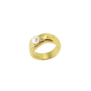 Macro shot of liquid metal lava style gold ring featuring a white baroque pearl center