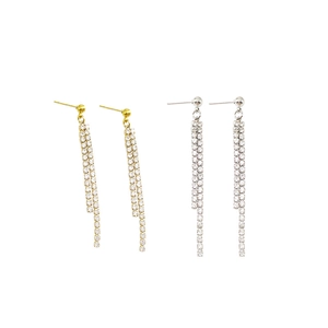 Detail of elegant gold and silver tassel earrings featuring double-row crystal rhinestones