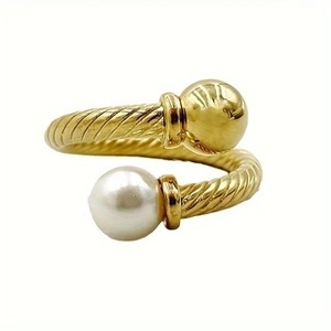 Gold open bypass cable ring featuring a polished metal ball and a white pearl accent
