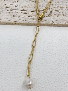 Close-up of golden paperclip link chain necklace with a white freshwater pearl pendant