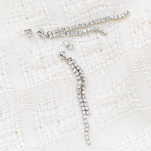 Detail of elegant long tassel earrings with sparkling double-row cubic zirconia