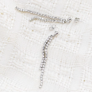 Detail of silver long tassel earrings with double rows of sparkling white zircons