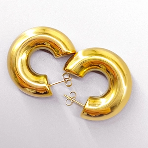 Macro detail of high-polished 18K gold-plated stainless steel thick C-shaped hoop earrings