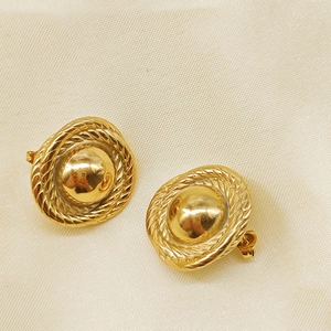 Macro detail of teardrop 18K gold-plated stainless steel earrings with woven texture