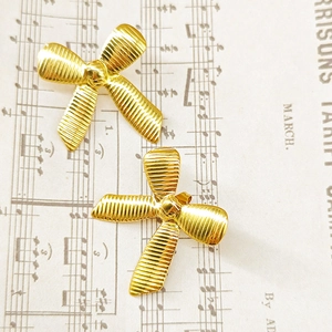 Elegant 18k gold plated stainless steel bow earrings with a textured ribbed finish