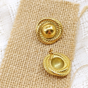 Macro detail of 18K gold stainless steel drop earrings with vintage twisted rope texture