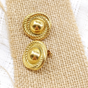 Detail of vintage 18K gold plated stainless steel teardrop studs on rustic linen lace background