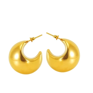 Macro shot of 18K gold plated chunky C-shaped hoop earrings with polished mirror finish