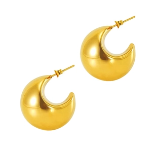 Detailed close-up of chunky gold crescent earrings with polished mirror finish
