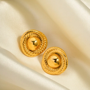 Detailed macro view of gold-plated teardrop earrings with classic rope texture detail