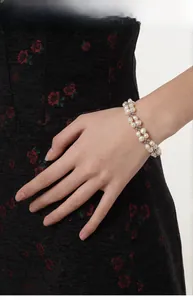 Double-strand baroque pearl bracelet with silver beads on a model's wrist
