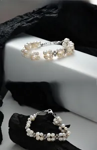 Macro detail of Baroque pearl bracelet with silver flower spacers and lobster clasp