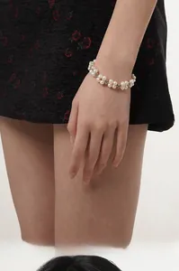Detail of woven S925 silver bracelet featuring white baroque pearls and silver beads