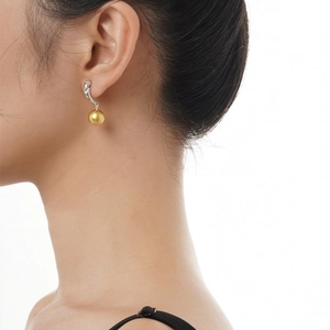 Elegant S925 sterling silver drop earrings with a lustrous golden pearl on model