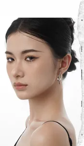 Close-up of irregular silver geometric earrings with a modern liquid metal design on model