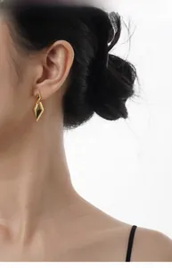 Polished gold geometric diamond earrings shown on model for elegant minimalist style